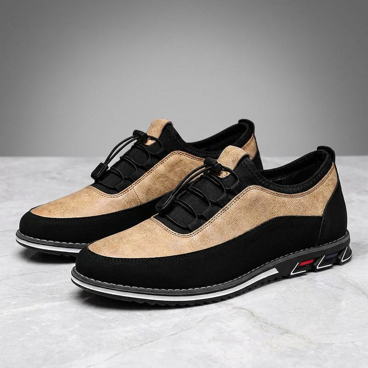 Sutri Leather Slip-On Shoes — Sand, pair in three-quarter view on light-grey marble