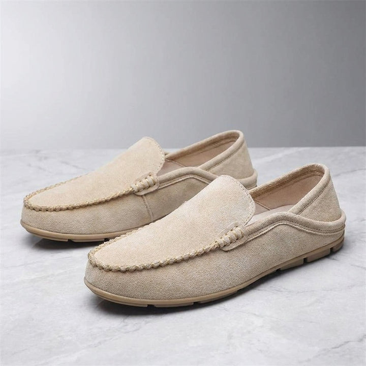 Menaggio Suede Loafers — Khaki, pair of loafers, three-quarter view on light grey marble