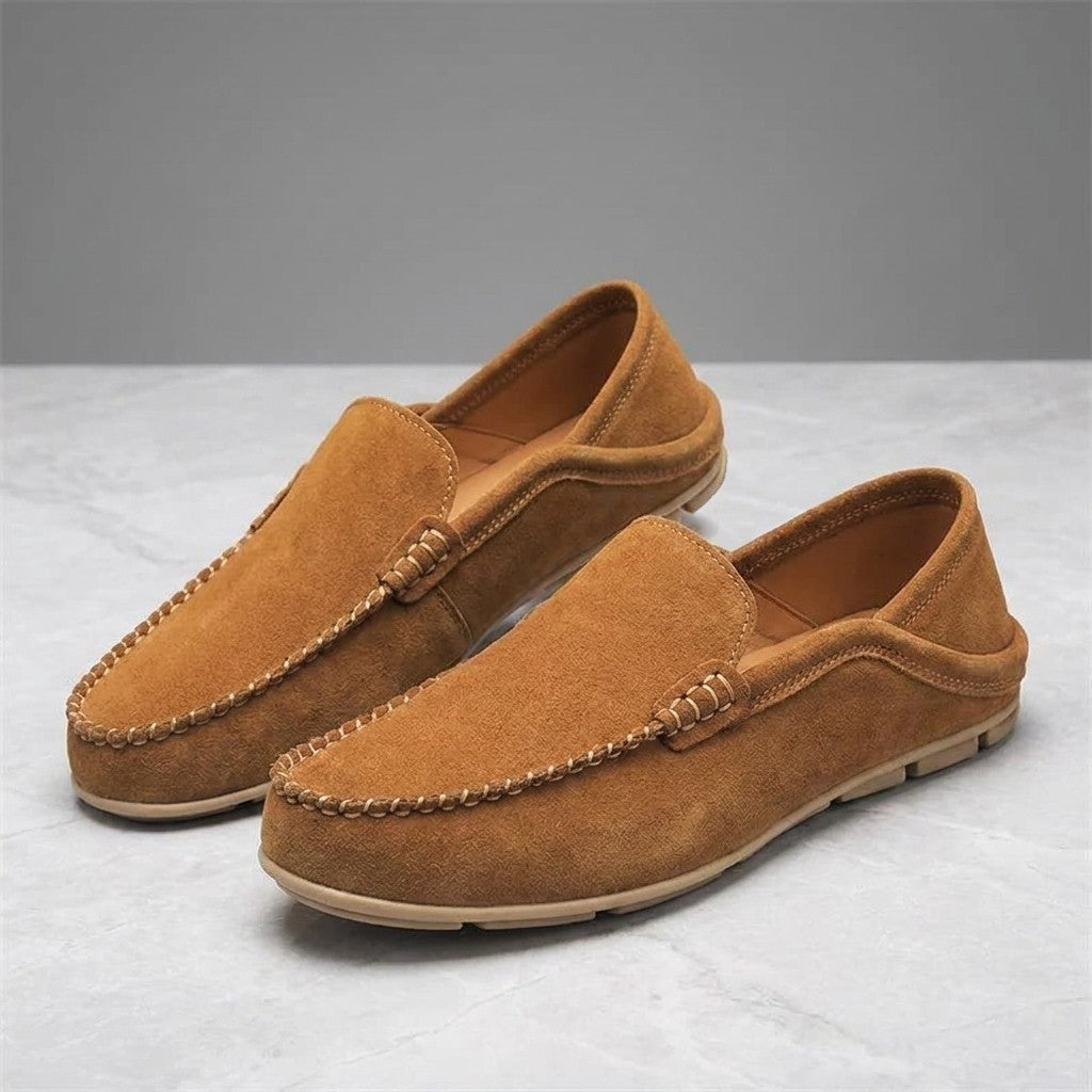 Menaggio Suede Loafers — Apricot, pair of loafers, three-quarter view on light grey marble