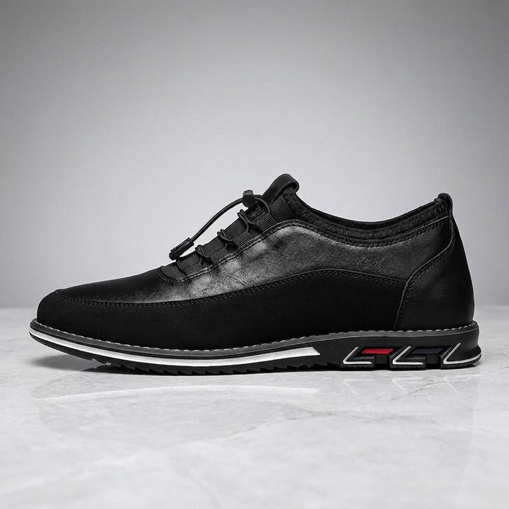 Sutri Leather Slip-On Shoes — Black, single shoe in side profile on light-grey marble