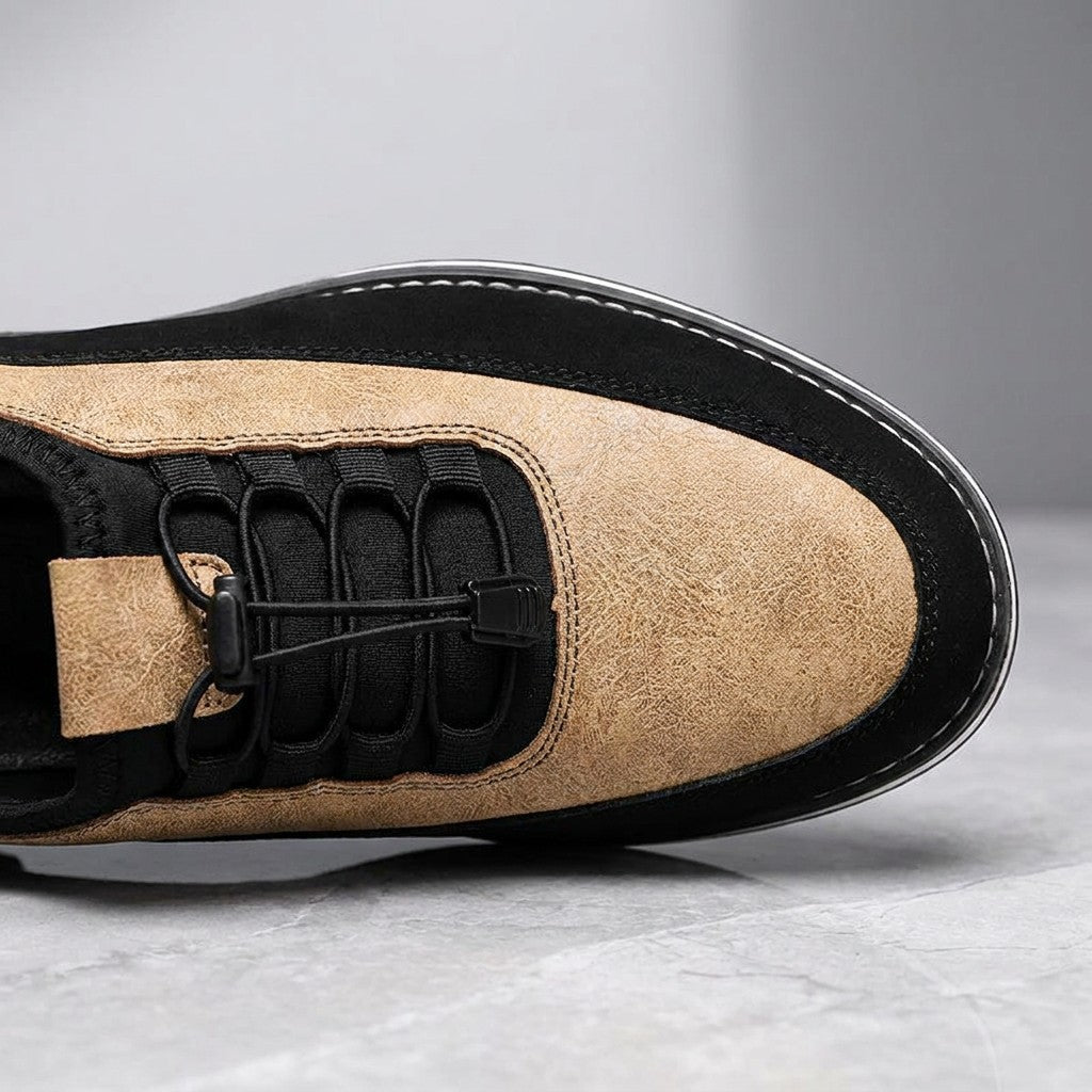Sutri Leather Slip-On Shoes — Sand, close-up of the elastic no-tie laces and stitched upper on light-grey marble