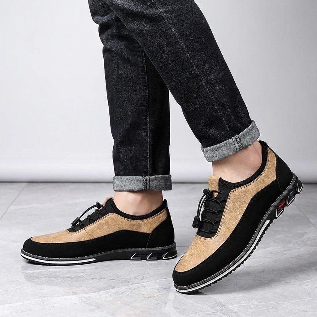 Sutri Leather Slip-On Shoes — Sand, worn with dark cuffed jeans, knee-down view on light-grey marble