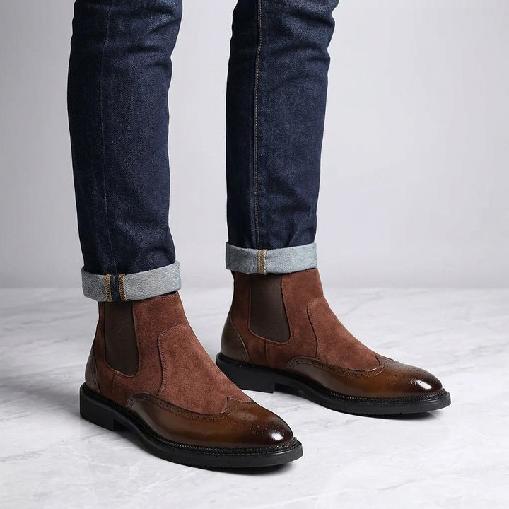 Montefalco Brogue Chelsea Boots — Brown, worn with cuffed dark jeans, knee-down on light grey marble