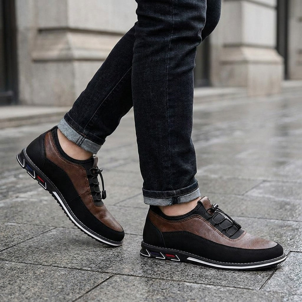 Sutri Leather Slip-On Shoes — Chestnut Brown, worn with dark cuffed jeans on a city sidewalk outside an office building