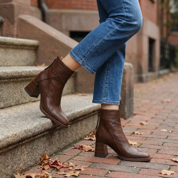 Tropea Paneled Ankle Boots — Brown, worn with cropped blue jeans on a brick sidewalk by brownstone steps