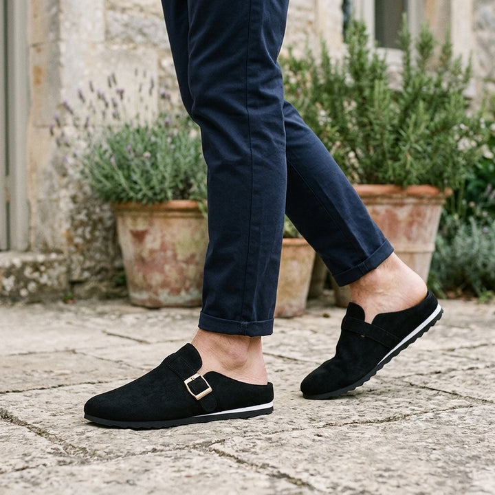 Ragusa Suede Mules — Black, worn on model, garden terrace