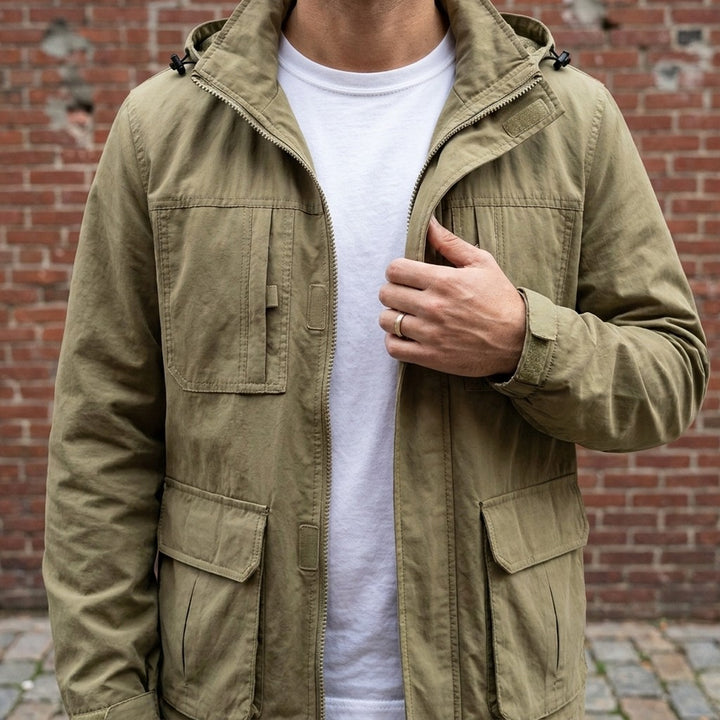 Close-up of the Pavia Hooded Cargo Jacket in Khaki worn over a white tee, showing the stand collar, hood and velcro chest pockets