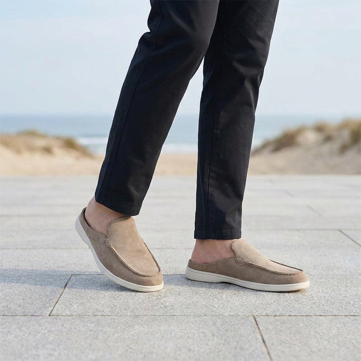 Salcombe Suede Loafers — Beige, male model knee-down coastal pavement