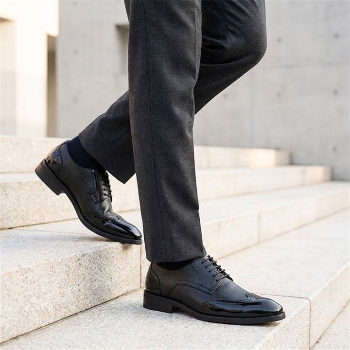 Urbino Leather Wingtip Brogues — Black, worn on stone steps