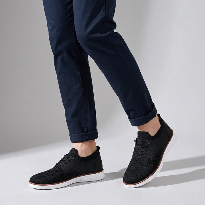Livorno Mesh Sneakers — Black, knee-down, studio backdrop, male model dark navy chinos
