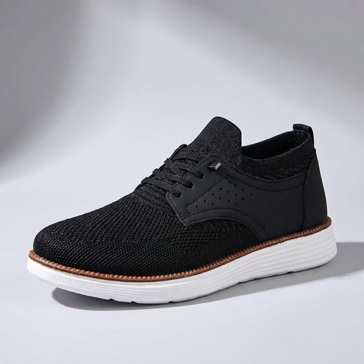 Livorno Mesh Sneakers — Black, three-quarter studio view, light-grey gradient backdrop