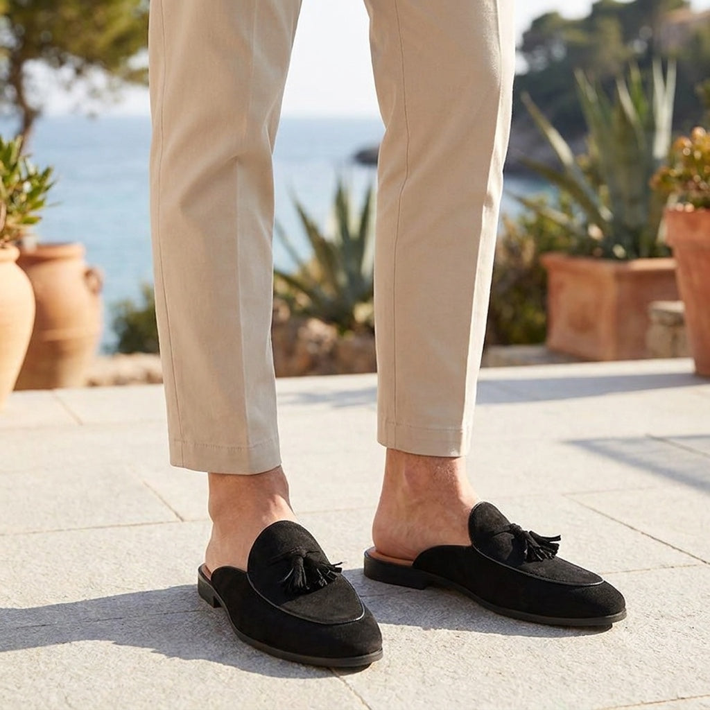 Fasano Suede Mules — Black, male model knee-down coastal terrace