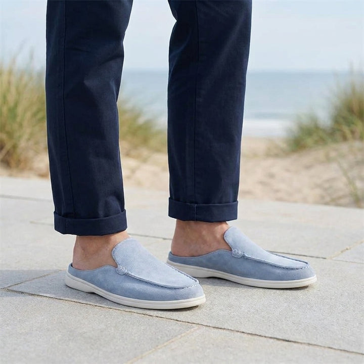 Salcombe Suede Loafers — Blue, male model knee-down coastal pavement