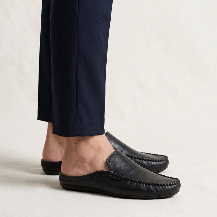 Cetara Leather Mules — Black, studio model knees down