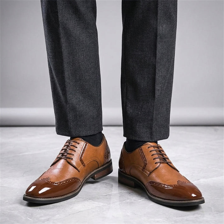 Urbino Leather Wingtip Brogues — Cognac, worn with suit trousers on a marble floor