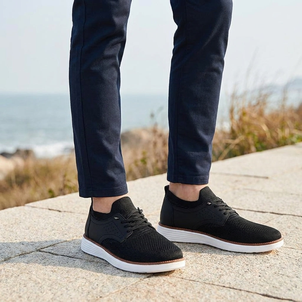 Livorno Mesh Sneakers — Black, knee-down, restrained coastal setting, male model dark navy chinos