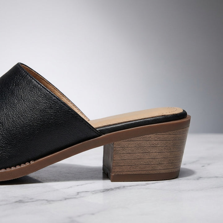 Sabina Leather Mules — Black, close-up of the block heel and stitched sole edge