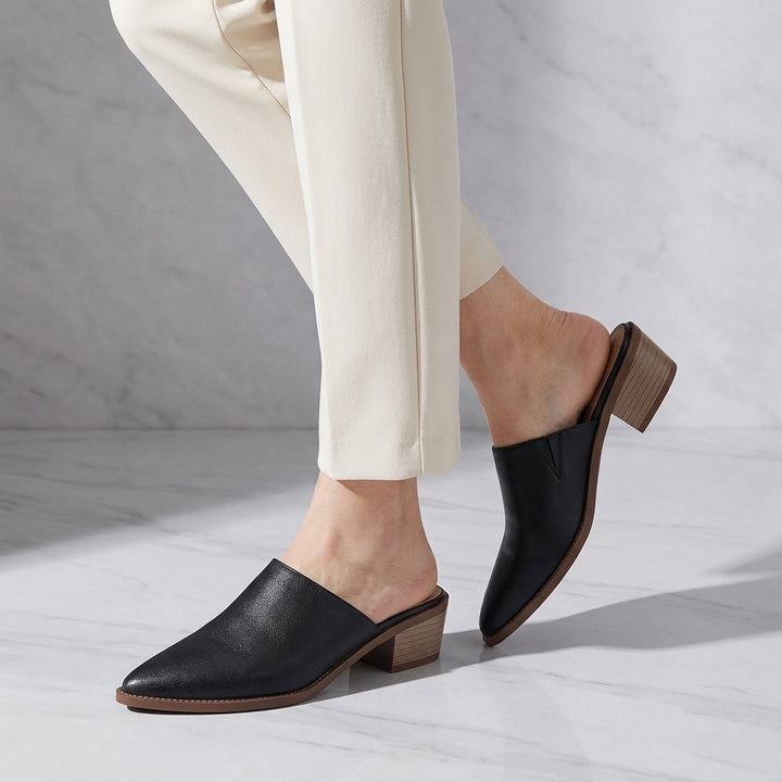 Sabina Leather Mules — Black, worn, studio view from the knee down