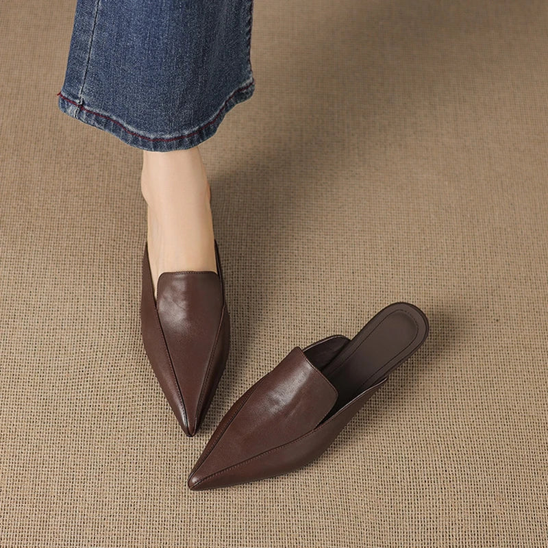 Cervia Leather Mules — Brown, worn with blue jeans, front three-quarter view