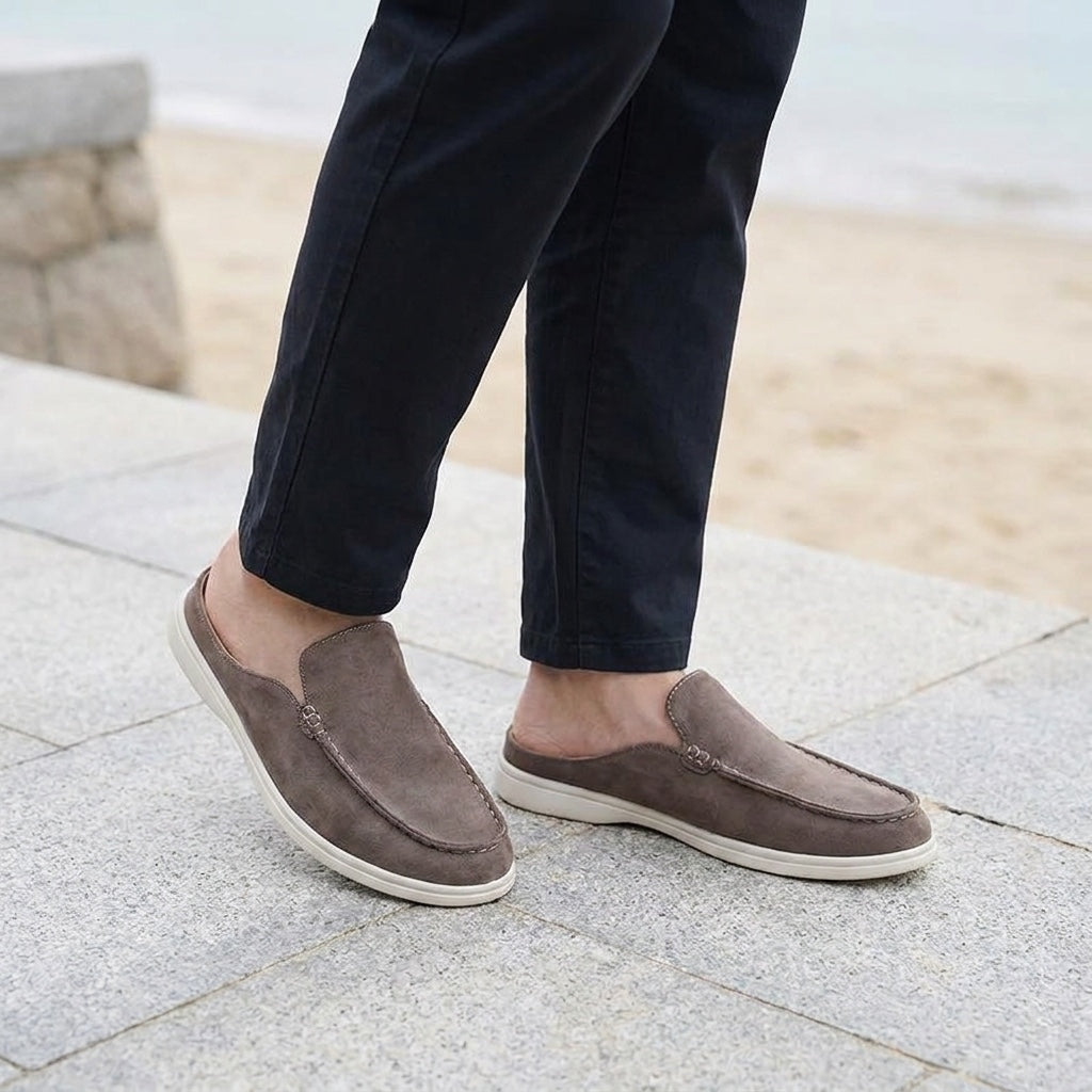Salcombe Suede Loafers — Brown, male model knee-down coastal pavement