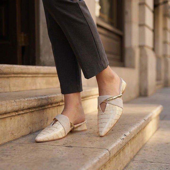 Orvieto Croc-Embossed Mules — Beige, on model at restaurant steps