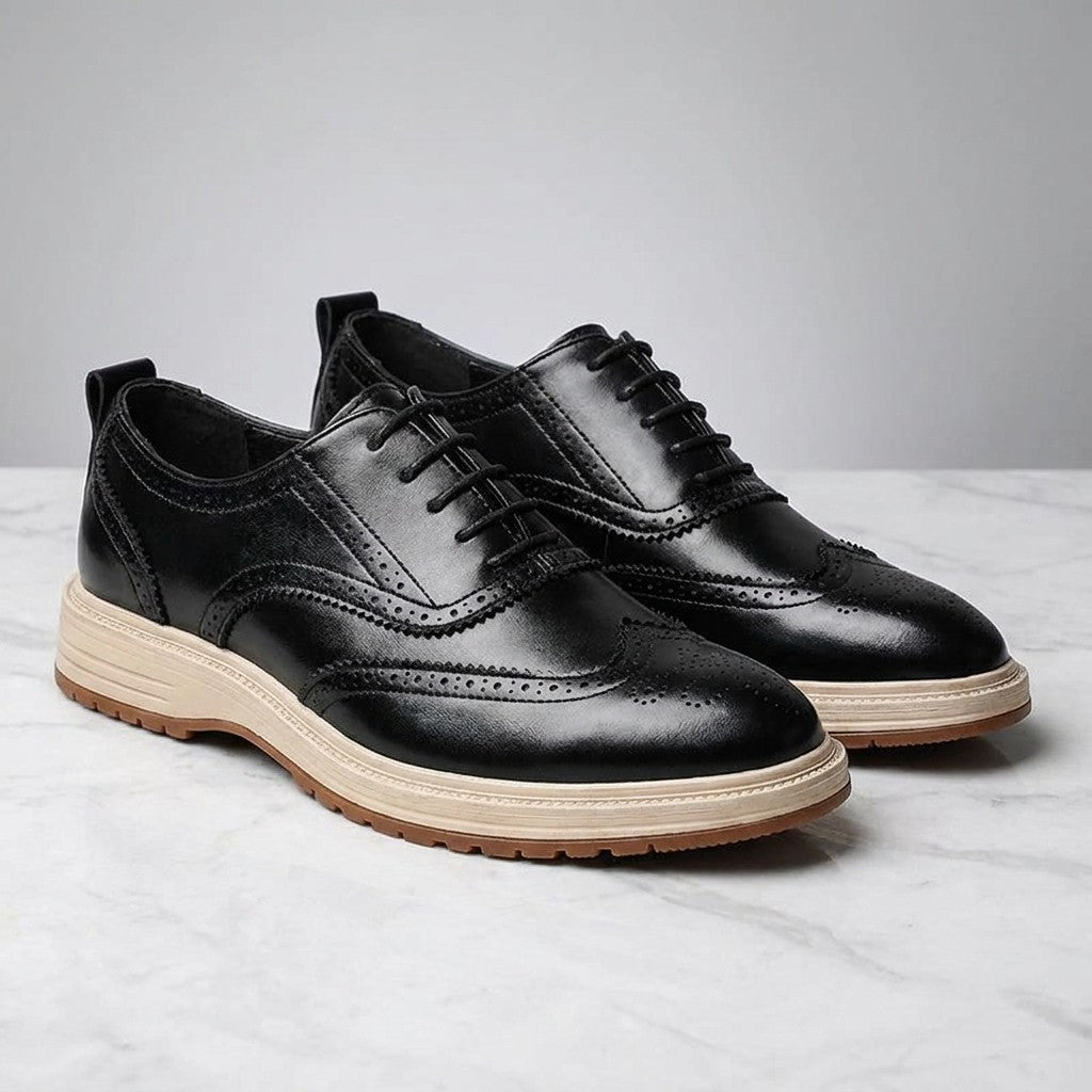 Trieste Brogue Sneakers — Black, pair on marble