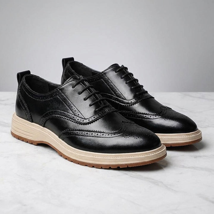 Trieste Brogue Sneakers — Black, pair on marble