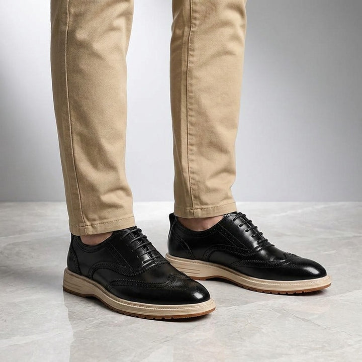 Trieste Brogue Sneakers — Black, on model knee-down studio