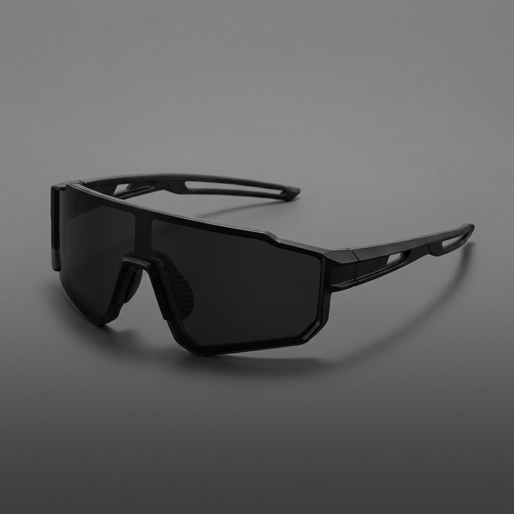 Scilla Shield Sunglasses — Black / Smoke, three-quarter front view on a grey studio gradient