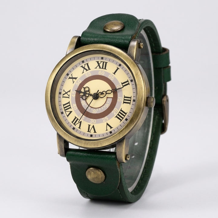 Sabaudia Vintage Watch — Bronze / Green Leather, cream Roman-numeral dial on a light-grey studio backdrop