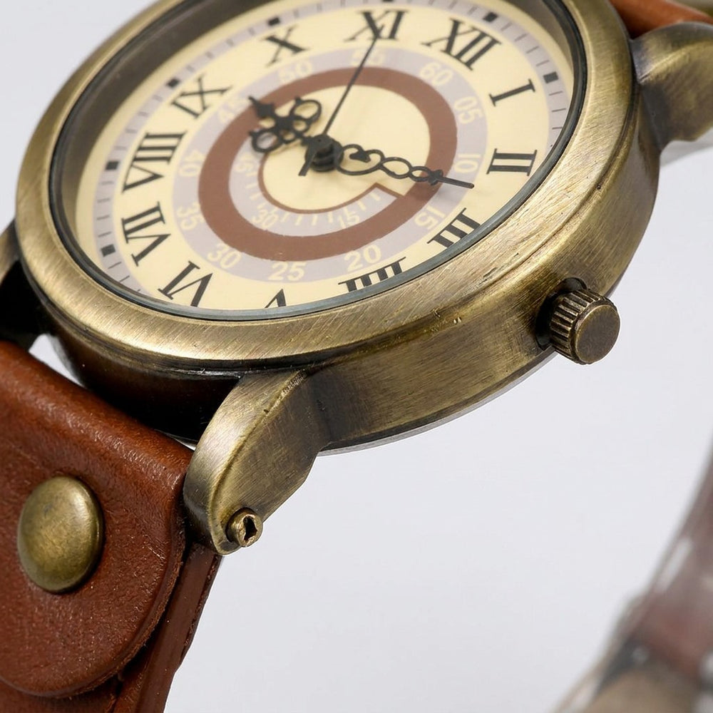 Sabaudia Vintage Watch — Bronze / Tan, close-up of the bronze-tone case, crown, lug and strap rivet