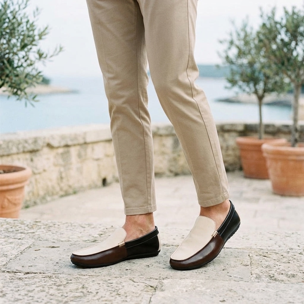 Salerno Two-Tone Loafers — Cream &amp; Brown, worn on a coastal stone terrace