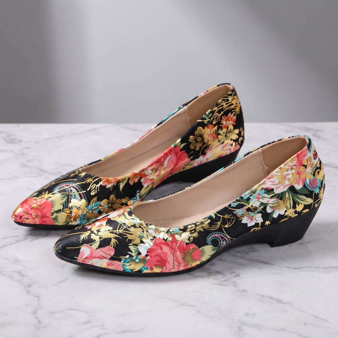 Camogli Floral Pumps — Black Floral, pair in three-quarter view on light-grey marble