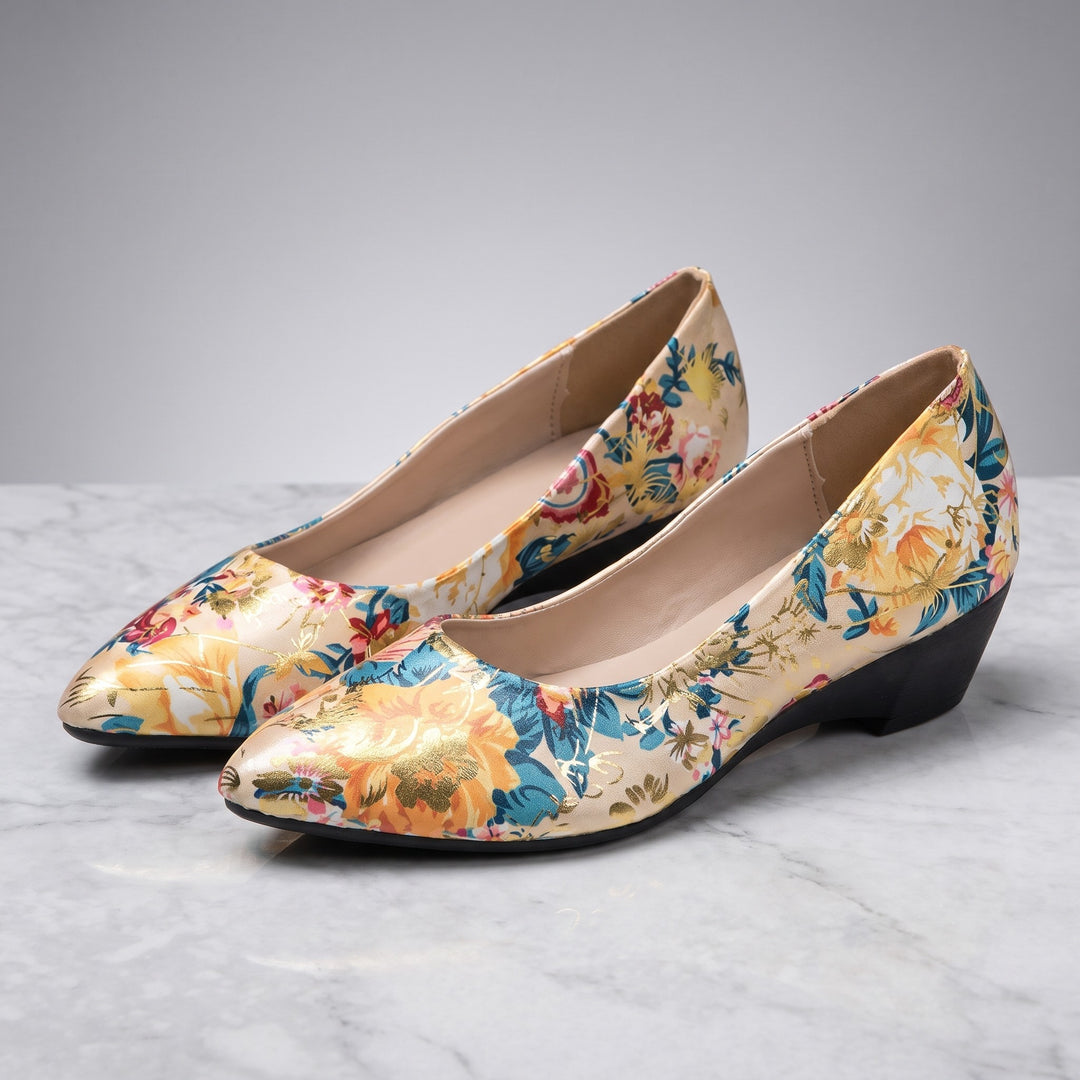 Camogli Floral Pumps — Cream Floral, pair in three-quarter view on light-grey marble