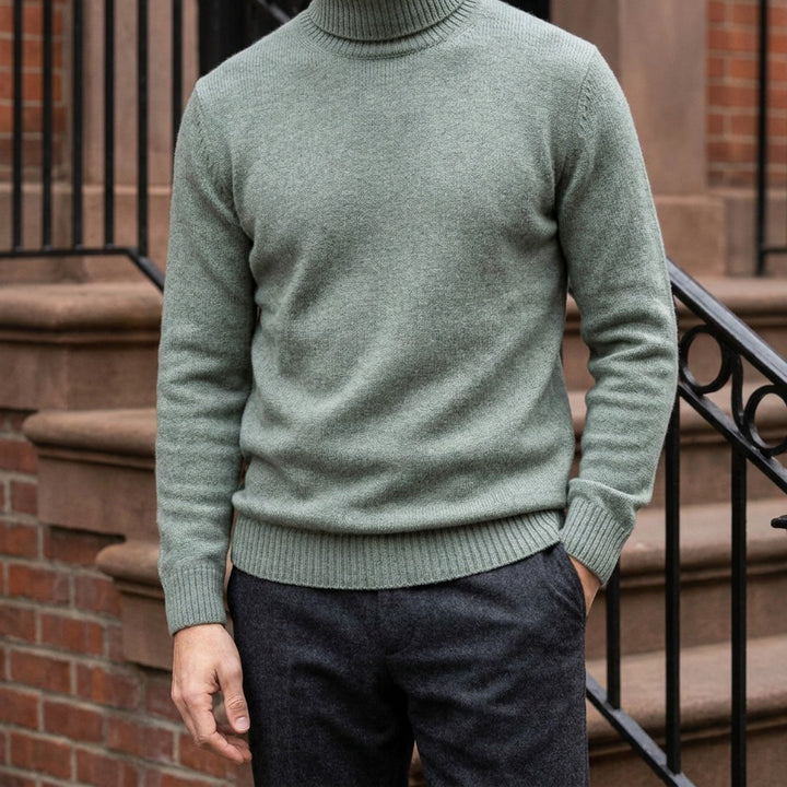 Cesena Merino Wool Turtleneck — Sage, worn on a brownstone stoop