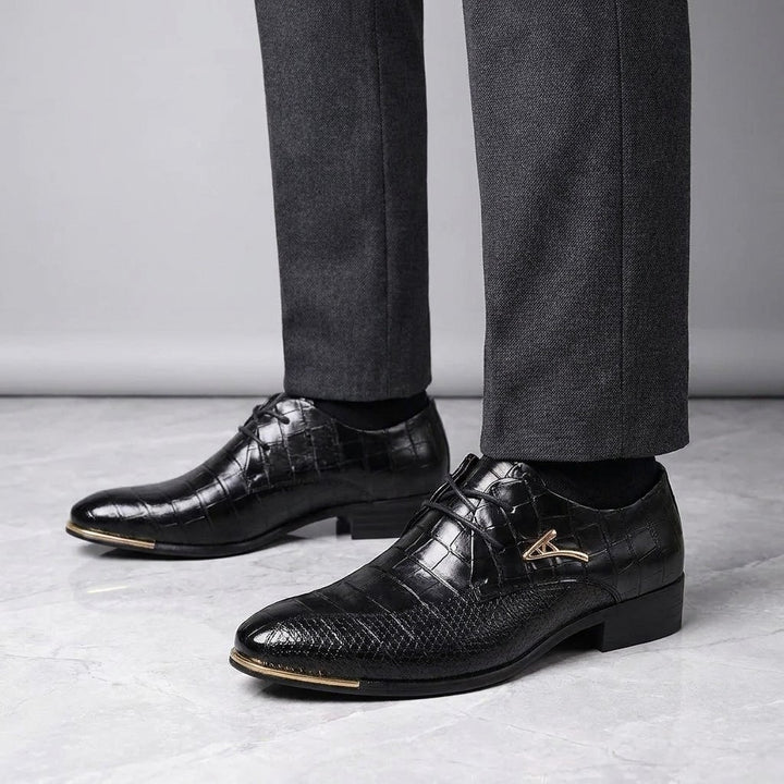 Cingoli Embossed Dress Shoes — Black, worn by a man, knee-down studio