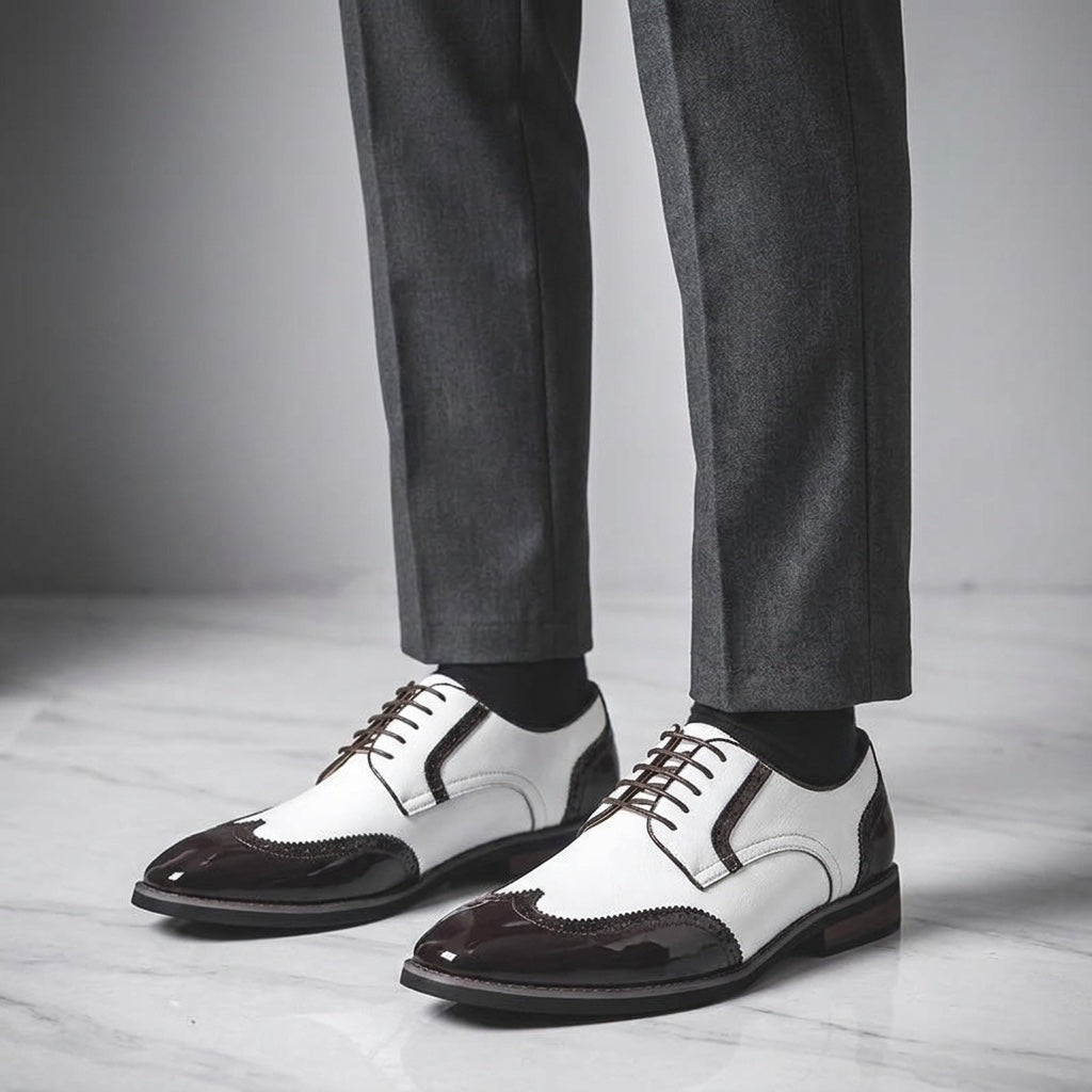 Urbino Leather Wingtip Brogues — White, worn with suit trousers on a marble floor