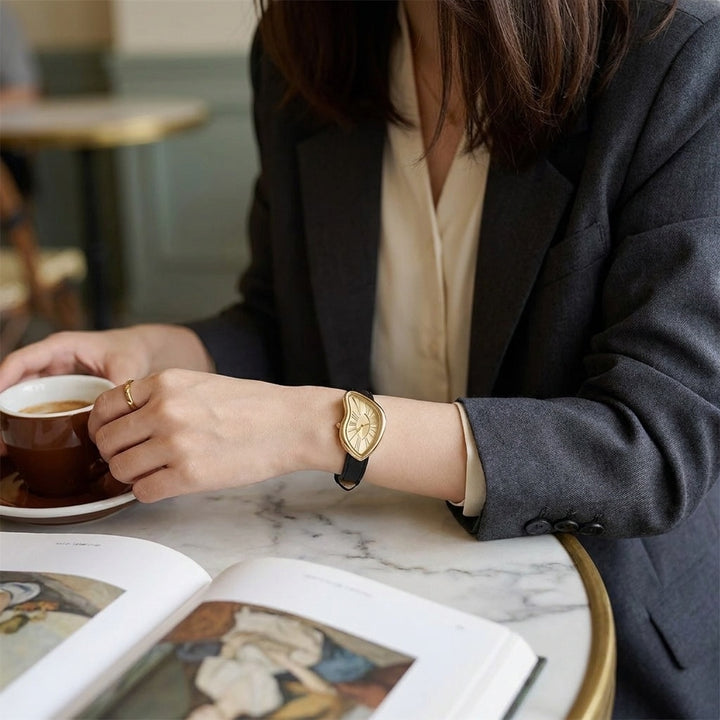 Navona Twisted Watch — Black Gold, worn at a cafe table