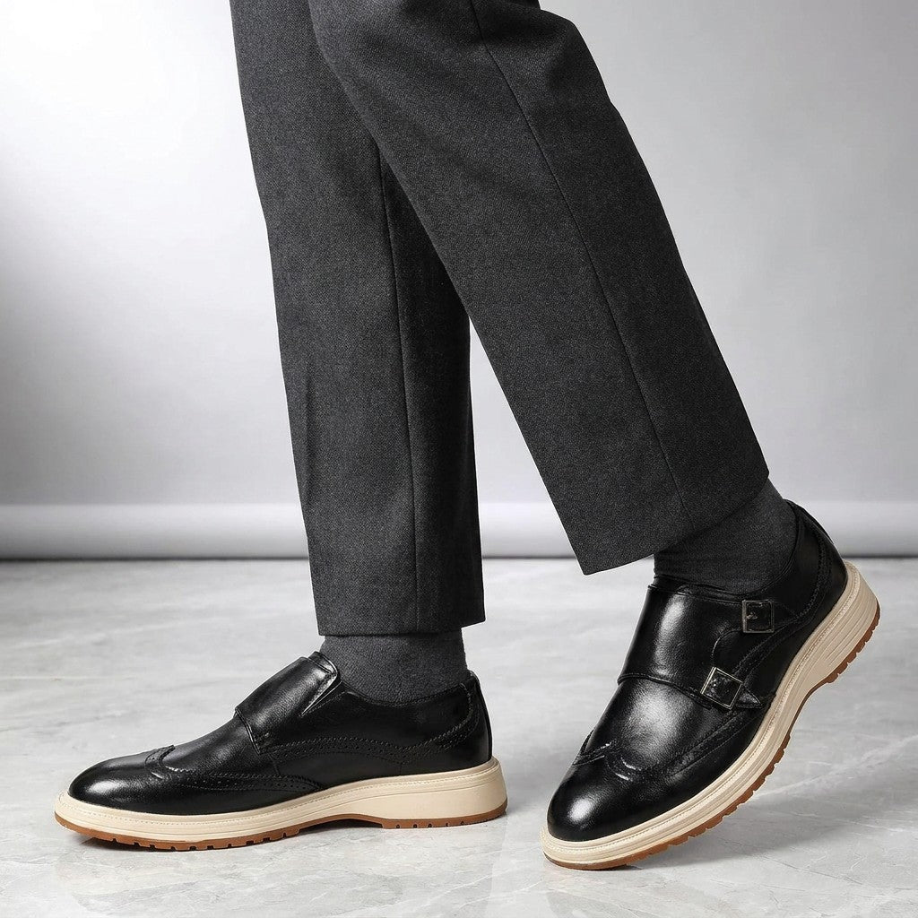 Gradara Leather Monk Shoes — Black, worn by a man, knee-down studio