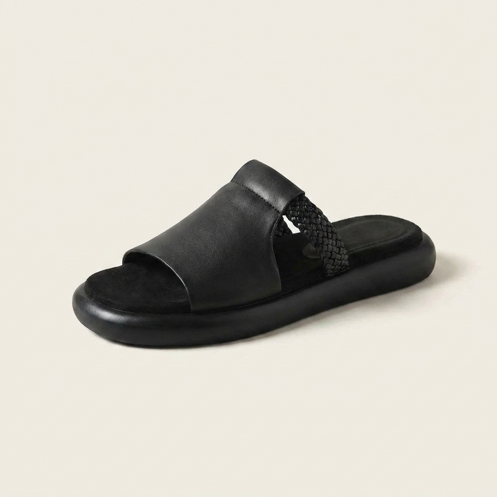 Marsala Leather Slides — Black, three-quarter studio view