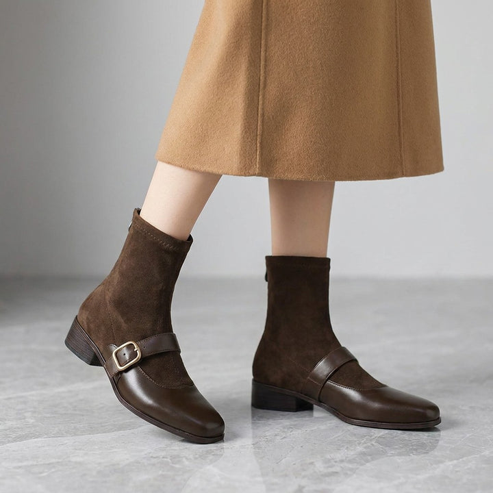 Pesaro Mary Jane Ankle Boots — Chocolate Brown, worn by a woman, knee down, on grey marble