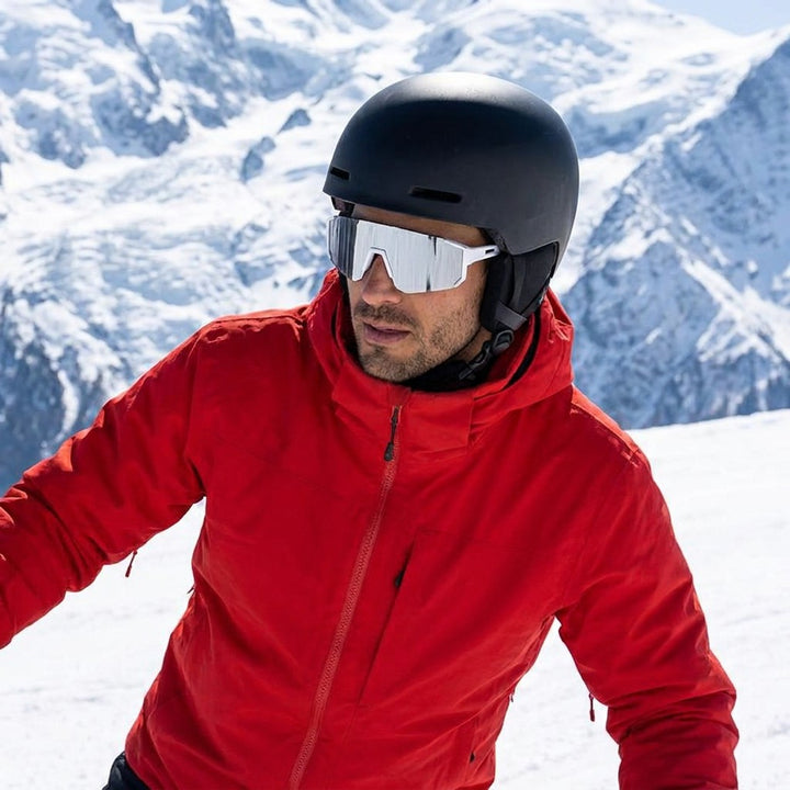 Scilla Shield Sunglasses — White / Silver Mirror, worn by a man in a helmet skiing in bright sun near Chamonix